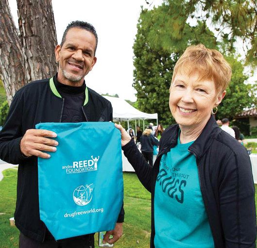 Andre Reed with the Reed Foundation and Drug-Free World swag bag containing Truth About Drugs education materials for annual Celebrity Golf Tournament attendees.